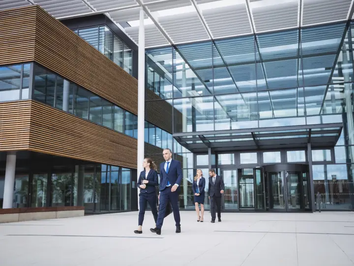 Legal professionals outside a modern office building