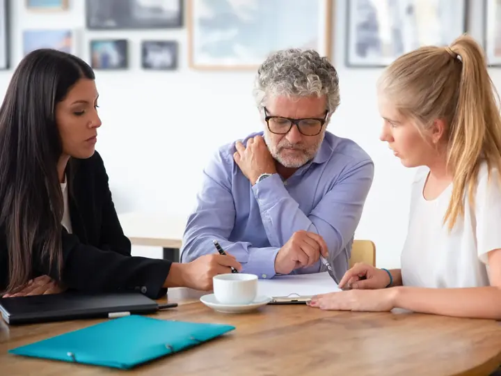 A will writer going through documents with a couple